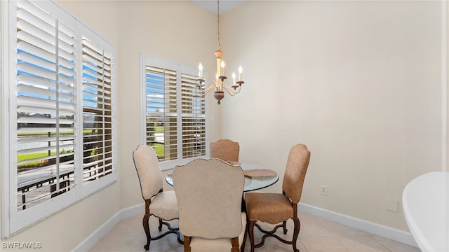 dining room with baseboards, a chandelier, and light tile patterned flooring