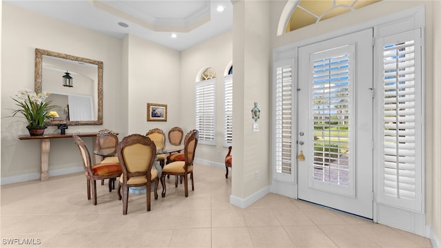 dining room with a wealth of natural light, recessed lighting, a tray ceiling, and ornamental molding