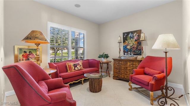 tiled living room featuring baseboards