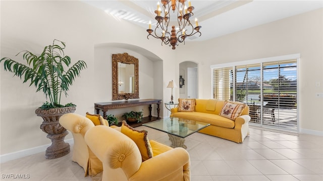 living room featuring tile patterned flooring, a chandelier, baseboards, and a tray ceiling