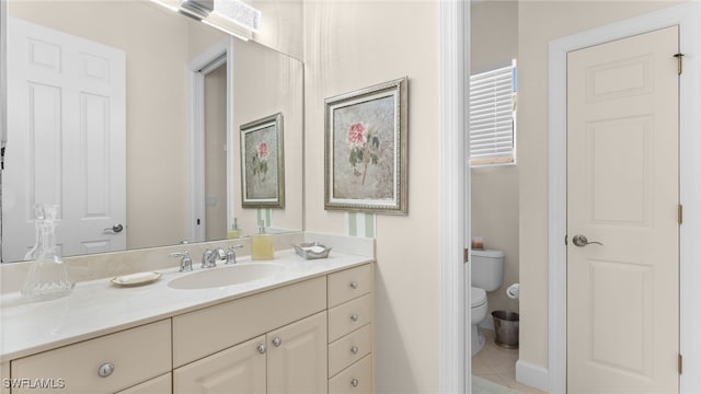 bathroom with tile patterned floors, toilet, and vanity