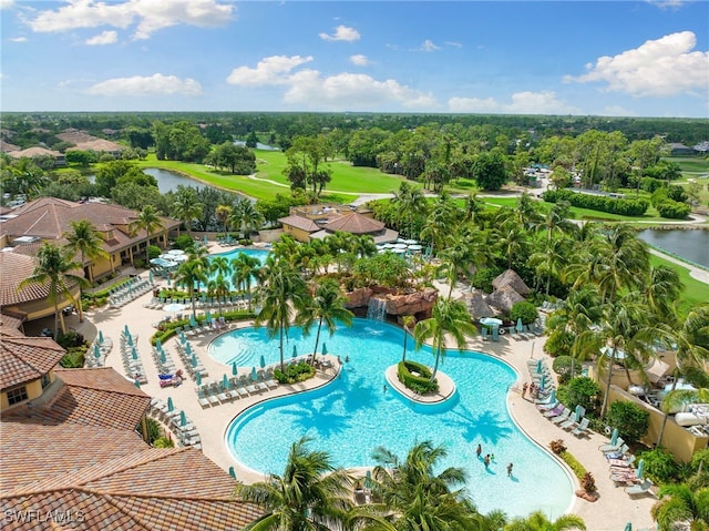 community pool featuring a water view and view of golf course