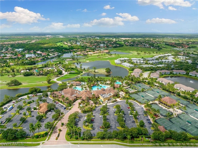 aerial view with golf course view, a water view, and a residential view