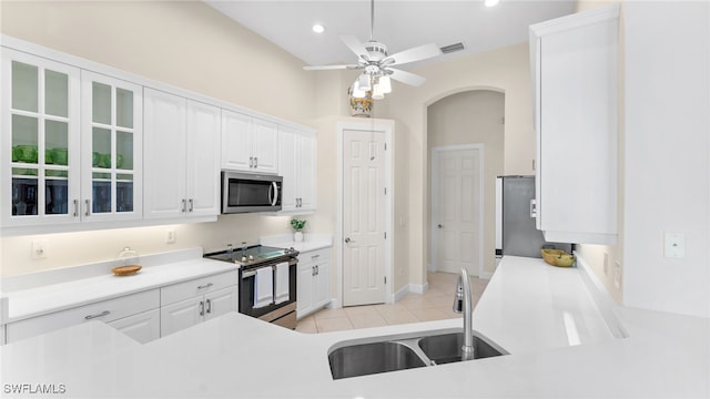 kitchen with light tile patterned floors, visible vents, a sink, white cabinets, and appliances with stainless steel finishes