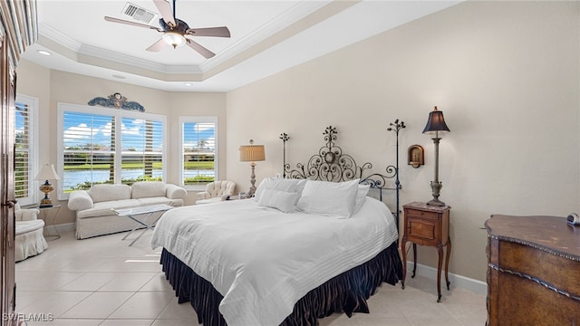 bedroom with visible vents, a tray ceiling, crown molding, light tile patterned floors, and baseboards