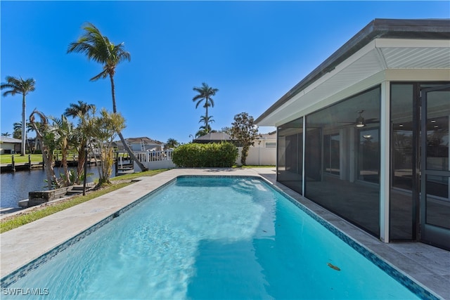 view of pool featuring a water view and a sunroom