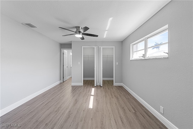 unfurnished bedroom with light hardwood / wood-style floors and ceiling fan