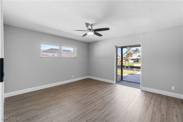 unfurnished room with hardwood / wood-style floors, a textured ceiling, and ceiling fan