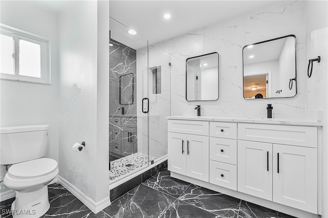 bathroom with vanity, toilet, and a shower with door