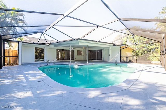 view of pool with a lanai, a patio area, and ceiling fan