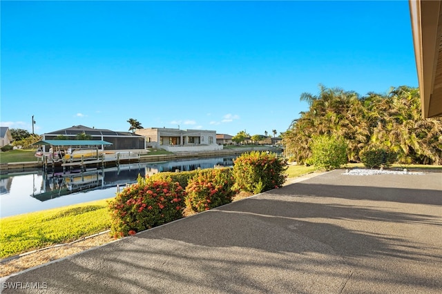 exterior space with a water view and a boat dock