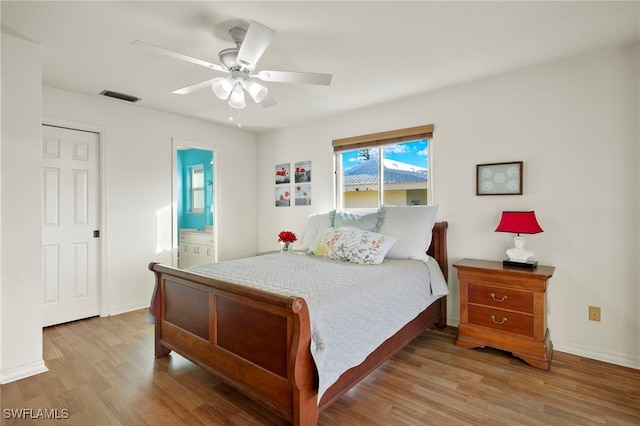 bedroom featuring connected bathroom, light hardwood / wood-style floors, and ceiling fan