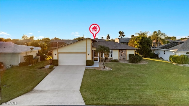 single story home featuring a garage and a front lawn