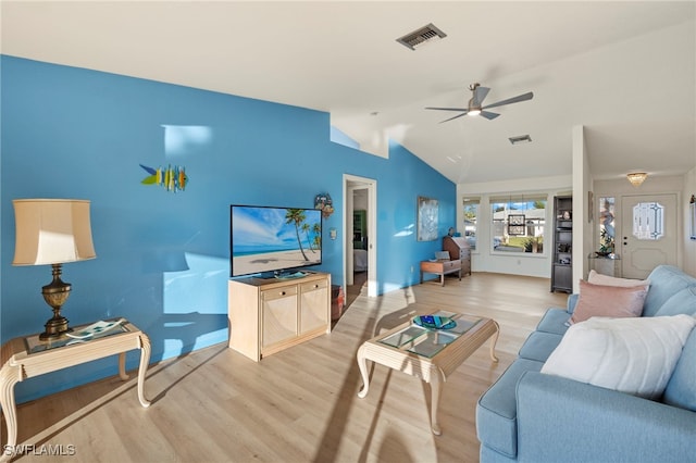 living room with hardwood / wood-style flooring, ceiling fan, and lofted ceiling