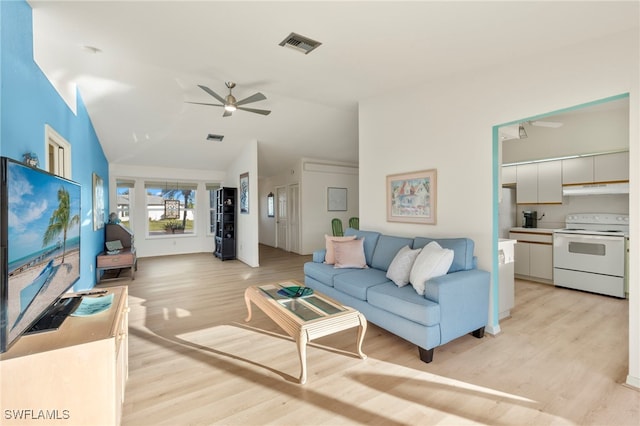 living room featuring ceiling fan, light hardwood / wood-style floors, and lofted ceiling