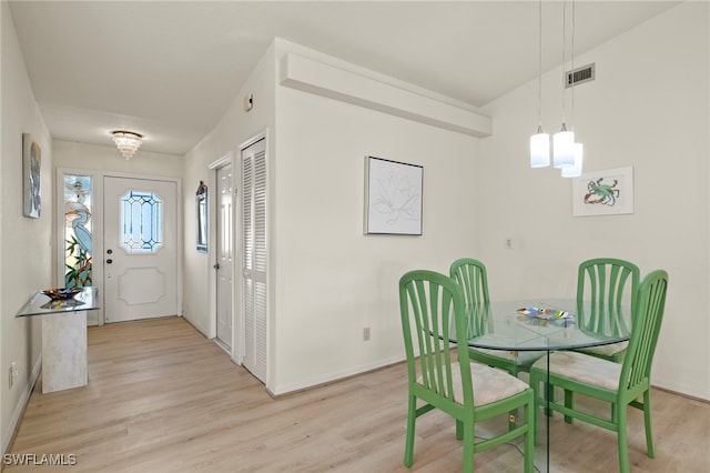 dining room featuring light hardwood / wood-style floors and an inviting chandelier