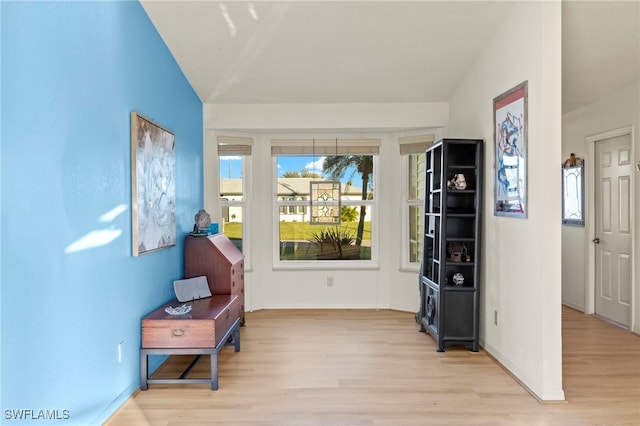 sitting room with lofted ceiling and light hardwood / wood-style flooring