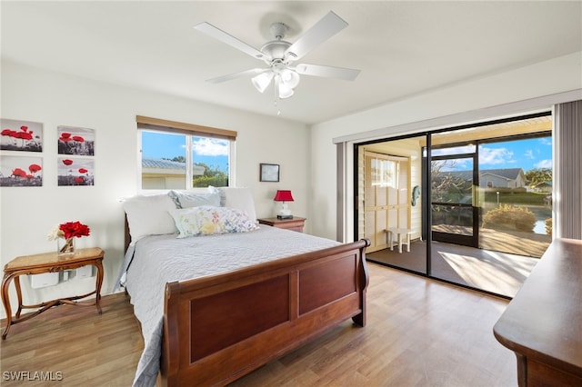 bedroom featuring hardwood / wood-style flooring, ceiling fan, and access to outside