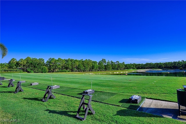 view of community with a lawn and a water view