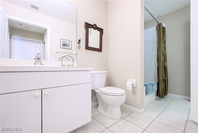 bathroom with tile patterned flooring, vanity, and toilet