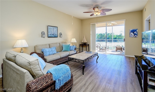 living room featuring light hardwood / wood-style flooring and ceiling fan