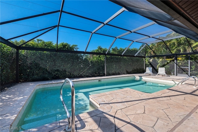 view of pool featuring glass enclosure and a patio area