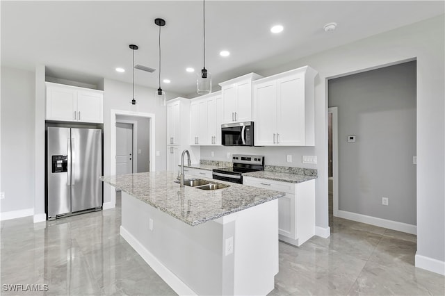 kitchen with a kitchen island with sink, white cabinets, and appliances with stainless steel finishes