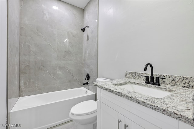 full bathroom featuring vanity, tiled shower / bath combo, and toilet