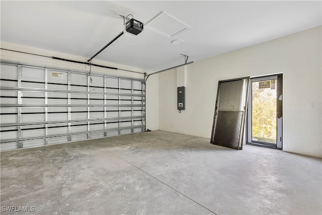 garage with electric panel and a garage door opener