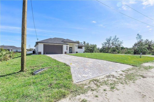 view of front of property featuring a garage and a front lawn