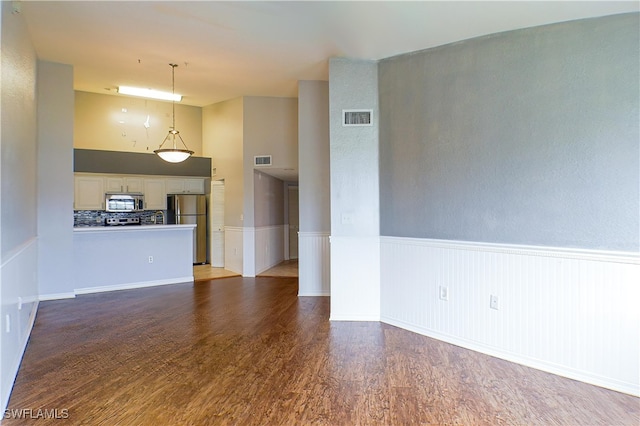 unfurnished living room featuring dark wood-type flooring