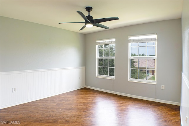 empty room with ceiling fan and dark wood-type flooring