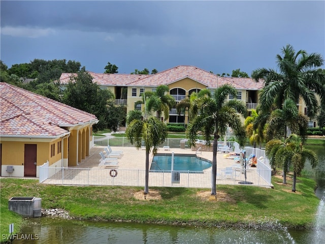 view of swimming pool with a patio area and a water view