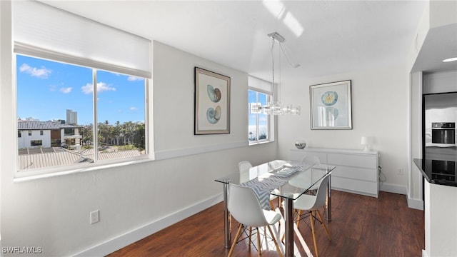 10420 Gulf Shore Dr Unit 143, Naples, FL 34108 - dining room featuring baseboards, dark wood-style floors, and a chandelier