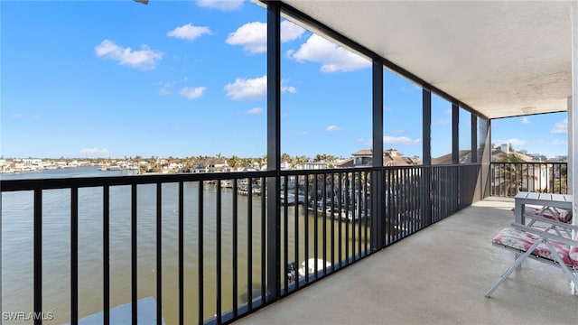 unfurnished sunroom featuring a water view