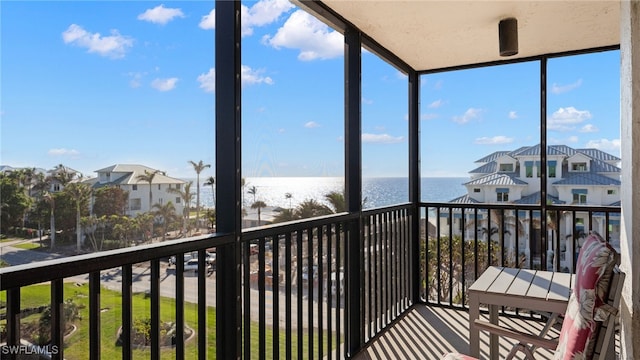 sunroom / solarium featuring a wealth of natural light and a water view