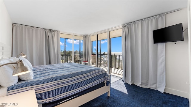 bedroom featuring access to outside and dark colored carpet