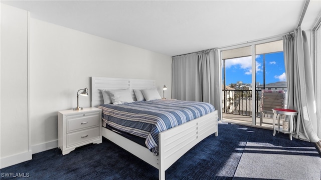 bedroom featuring access to outside and dark carpet