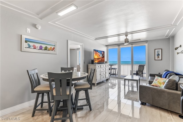 dining space featuring floor to ceiling windows, ceiling fan, and light hardwood / wood-style floors