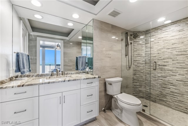 bathroom with vanity, ceiling fan, hardwood / wood-style floors, toilet, and a shower with shower door