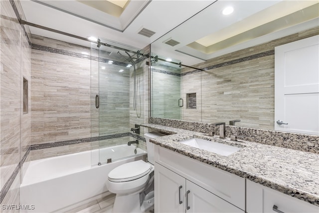 full bathroom featuring shower / bath combination with glass door, vanity, and toilet