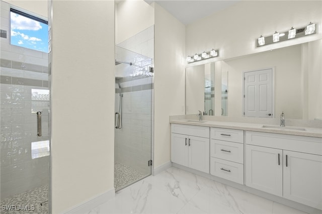 bathroom with vanity and a shower with door