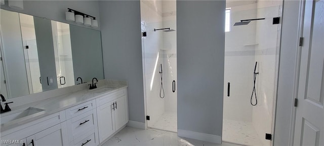 bathroom featuring a sink, baseboards, marble finish floor, and a stall shower
