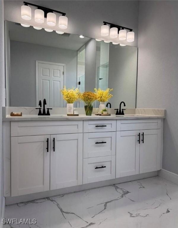 5028 Billings St, Lehigh Acres, FL 33971 - full bath with marble finish flooring, double vanity, and baseboards