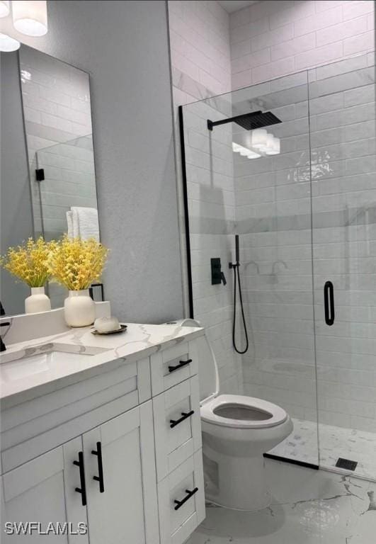 5028 Billings St, Lehigh Acres, FL 33971 - bathroom featuring marble look tile flooring, vanity, a stall shower, and toilet
