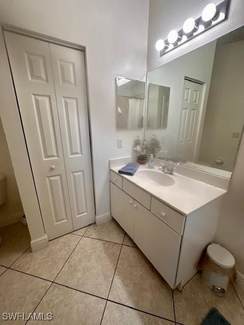 bathroom with tile patterned floors, vanity, and toilet