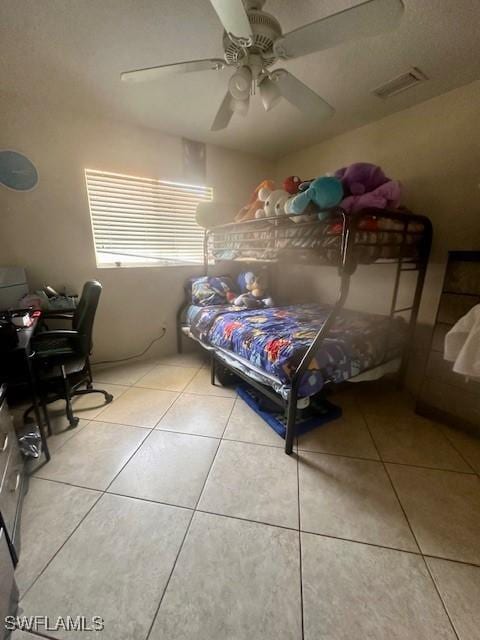 tiled bedroom with ceiling fan