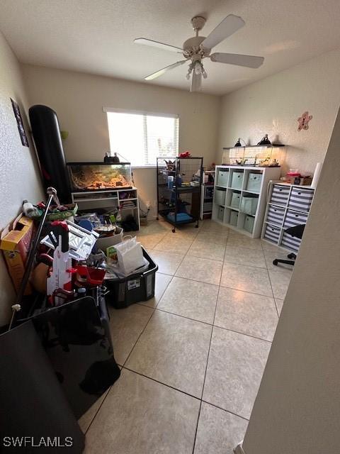 office with ceiling fan and light tile patterned floors