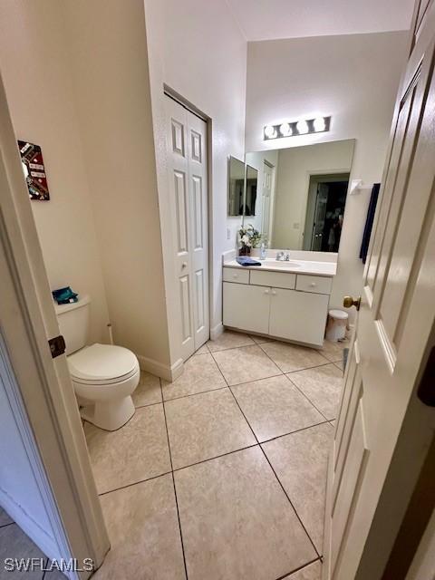 bathroom with tile patterned floors, vanity, and toilet