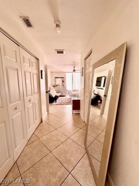 corridor featuring light tile patterned floors